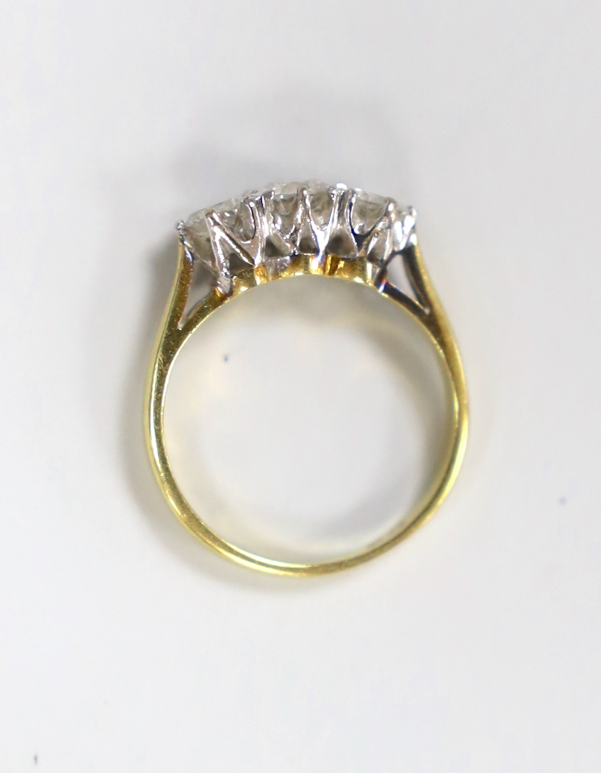 A modern 18ct gold and three stone diamond set ring, size I, gross weight 2.9 grams.